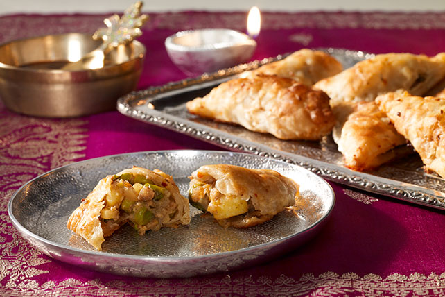 Vegetarian samosas on metal serving plate
